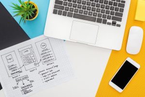 top view of website design template near laptop, computer mouse, smartphone, plant on abstract