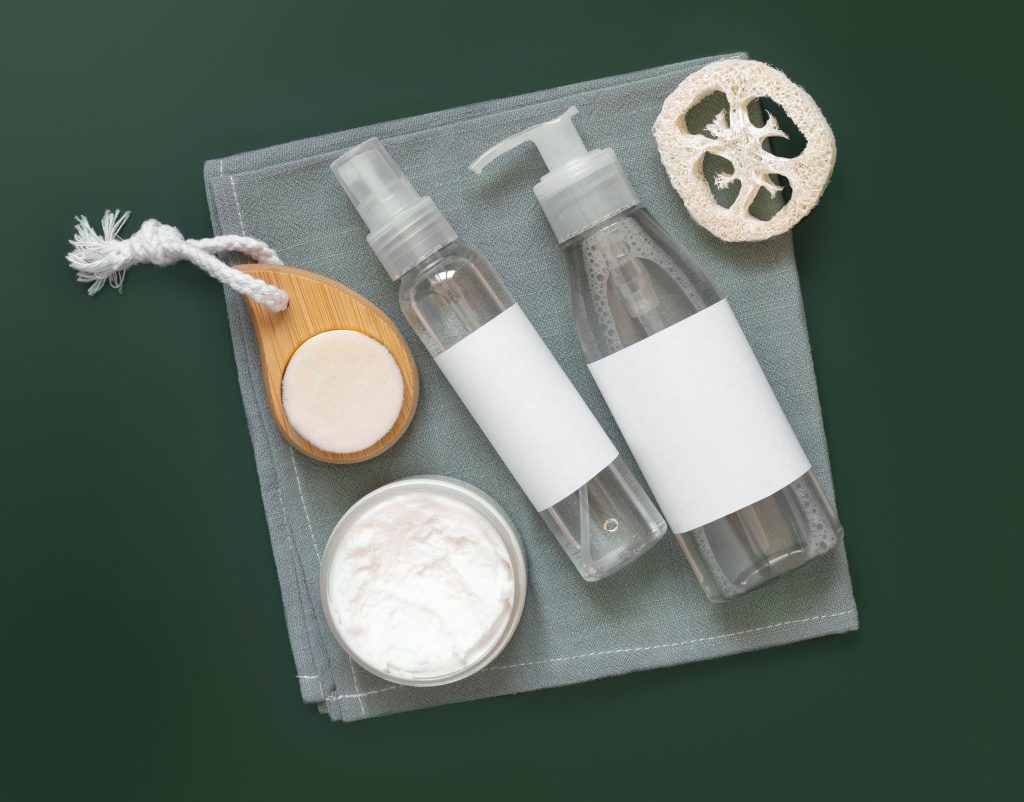 flat lay with organic natural cosmetics and zero waste reusable accessories for skin and hair care on table